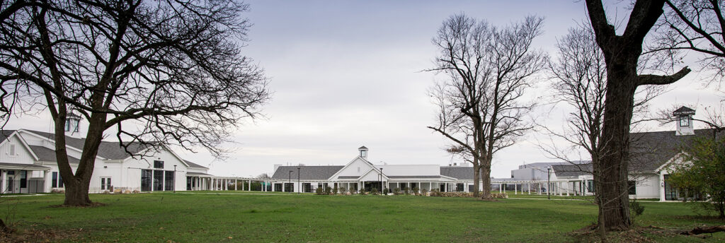 Three North Central buildings in front of a grass field.