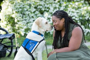 Women nose to nose with her service dog