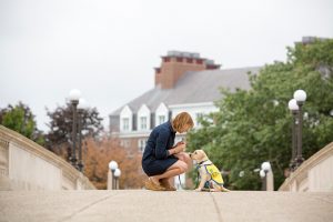 Lady with puppy on a small bridge