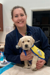 Veterinarian Dr. Sarah Lee with a yellow Canine Companions puppy