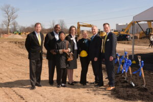 Board members standing in dirt field at ground breaking of the new North Central Campus