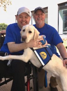 graduates with service dog