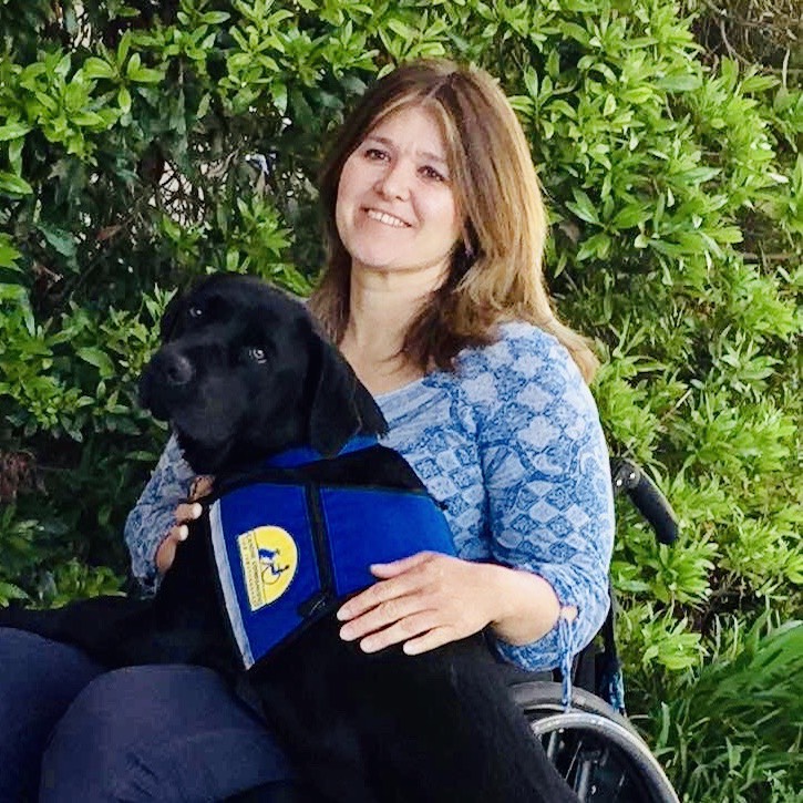 Volunteer and graduate JoAnna Johnstone with her yellow service dog, Yala