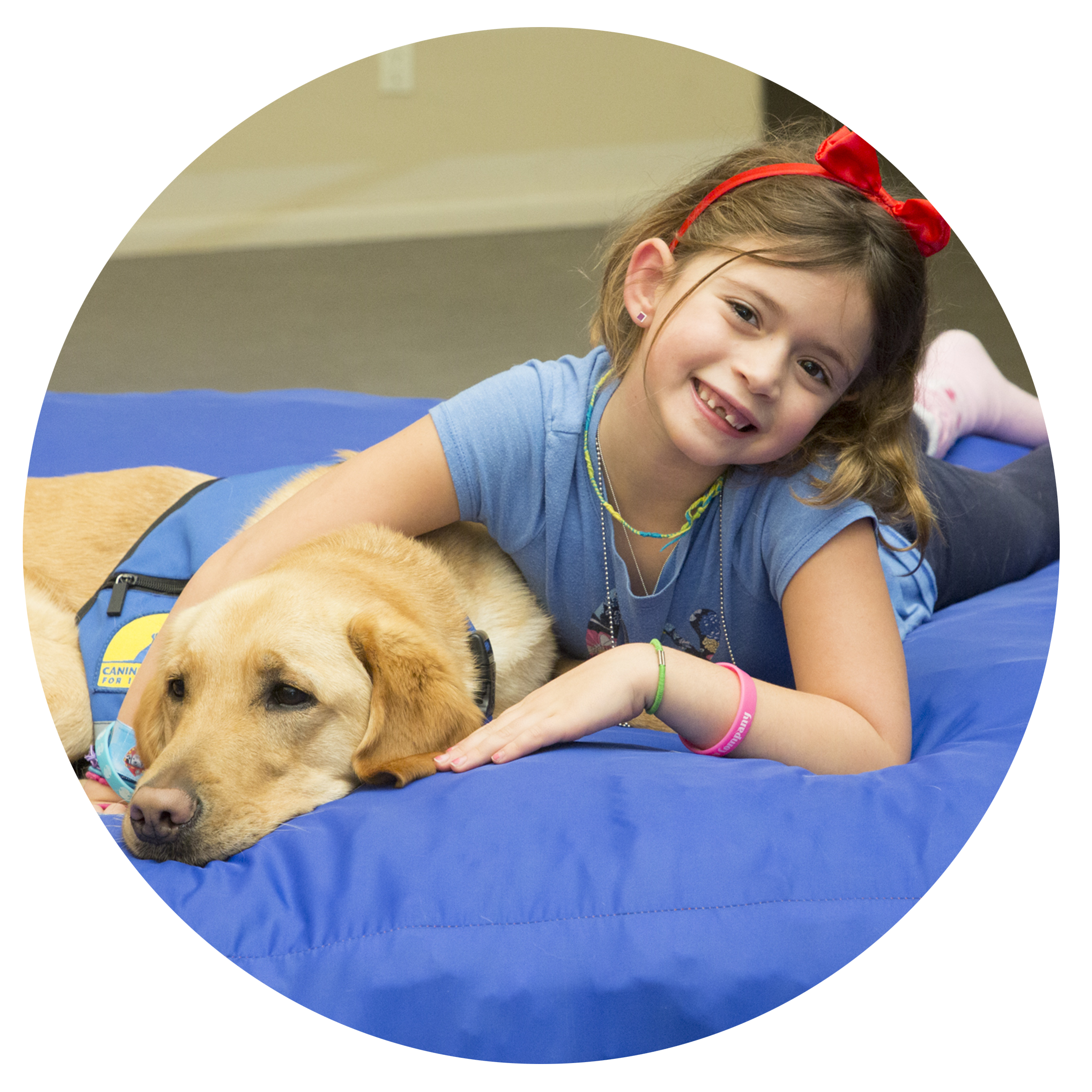 young girl and yellow lab laying down